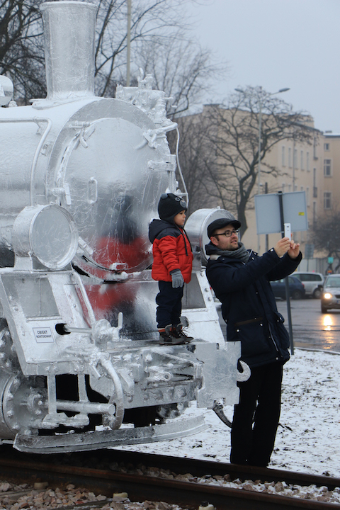 Father and son in front of train